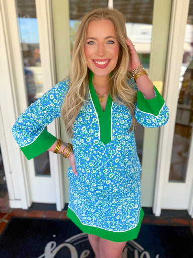 Blue, green, and white floral dress with green trim 
