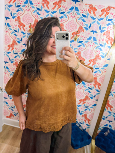 This camel top features a relaxed silhouette with short puff sleeves, subtle seam detailing, and beautiful embroidered cutout detail along the scalloped hem.