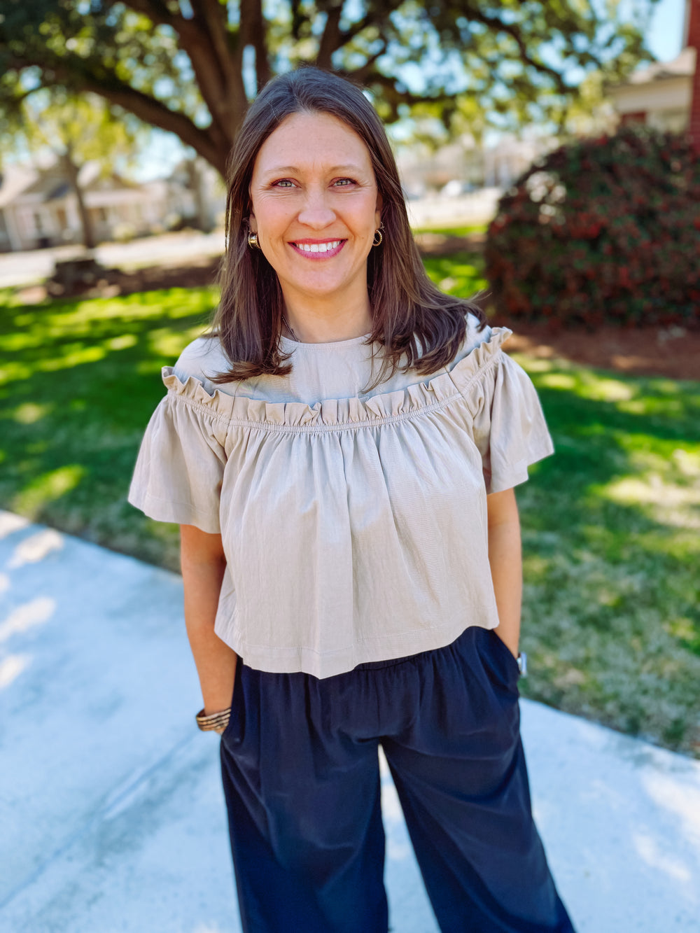 Cropped beige blouse with ruffle detailing 