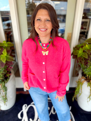 This fuzzy knit cardigan features a classic button-front design with an easy, relaxed fit and front patch pockets
