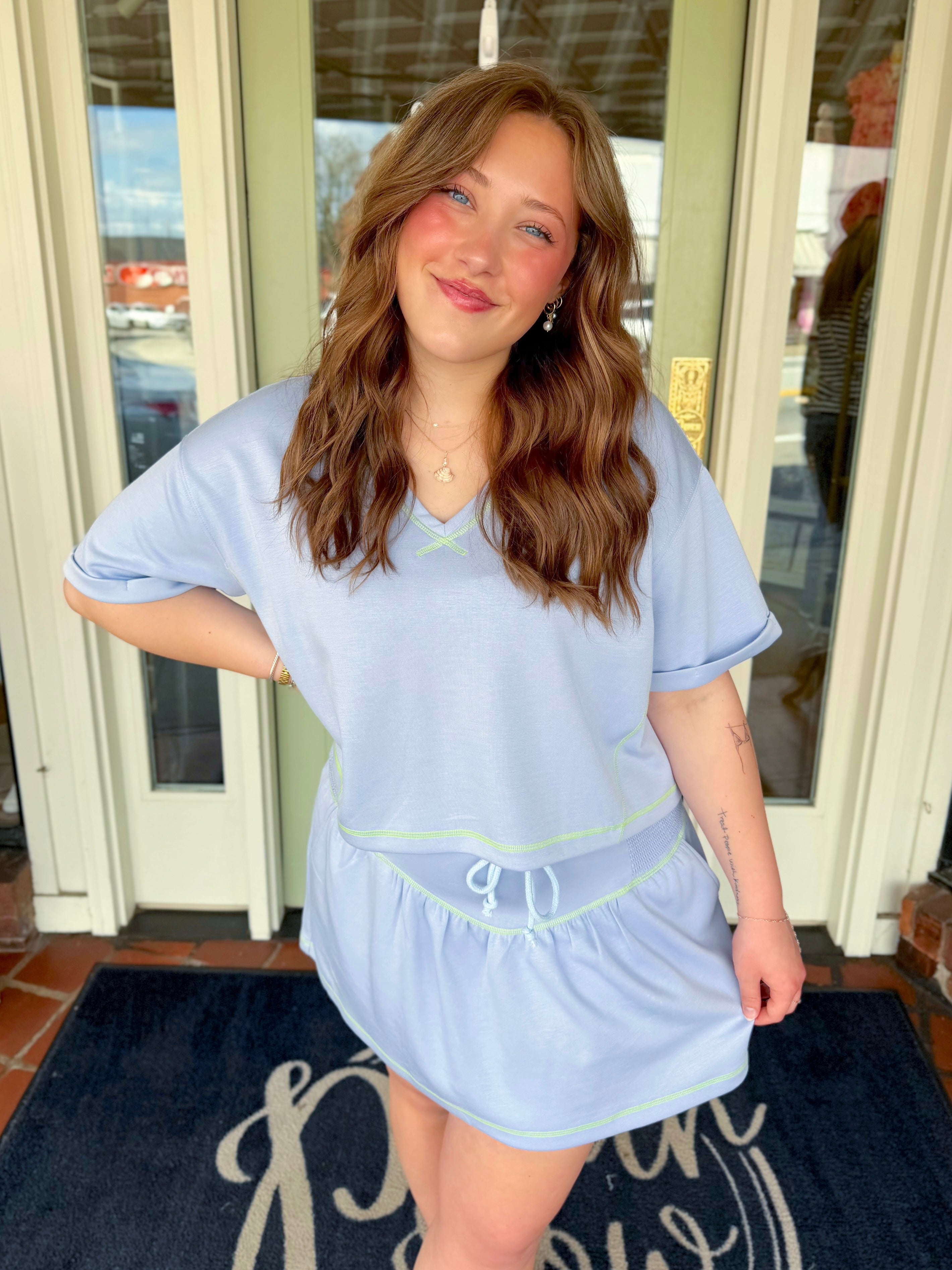 Soft knit top with green thread detail 