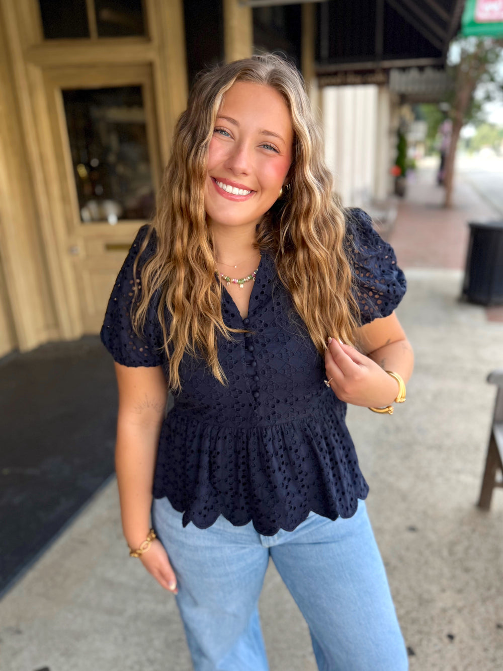 Navy blue short-sleeve eyelet lace peplum top.