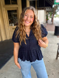 Navy blue short-sleeve eyelet lace peplum top.