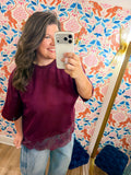  This top features a relaxed silhouette with a delicate lace hem that adds the perfect feminine touch. 