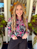 This black button-down top features a colorful botanical print in vibrant pink, mint, green, and soft neutral tones.