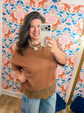  This top features a relaxed silhouette with a delicate lace hem that adds the perfect feminine touch. 