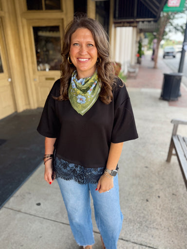 A black short-sleeve top with a lace hem
