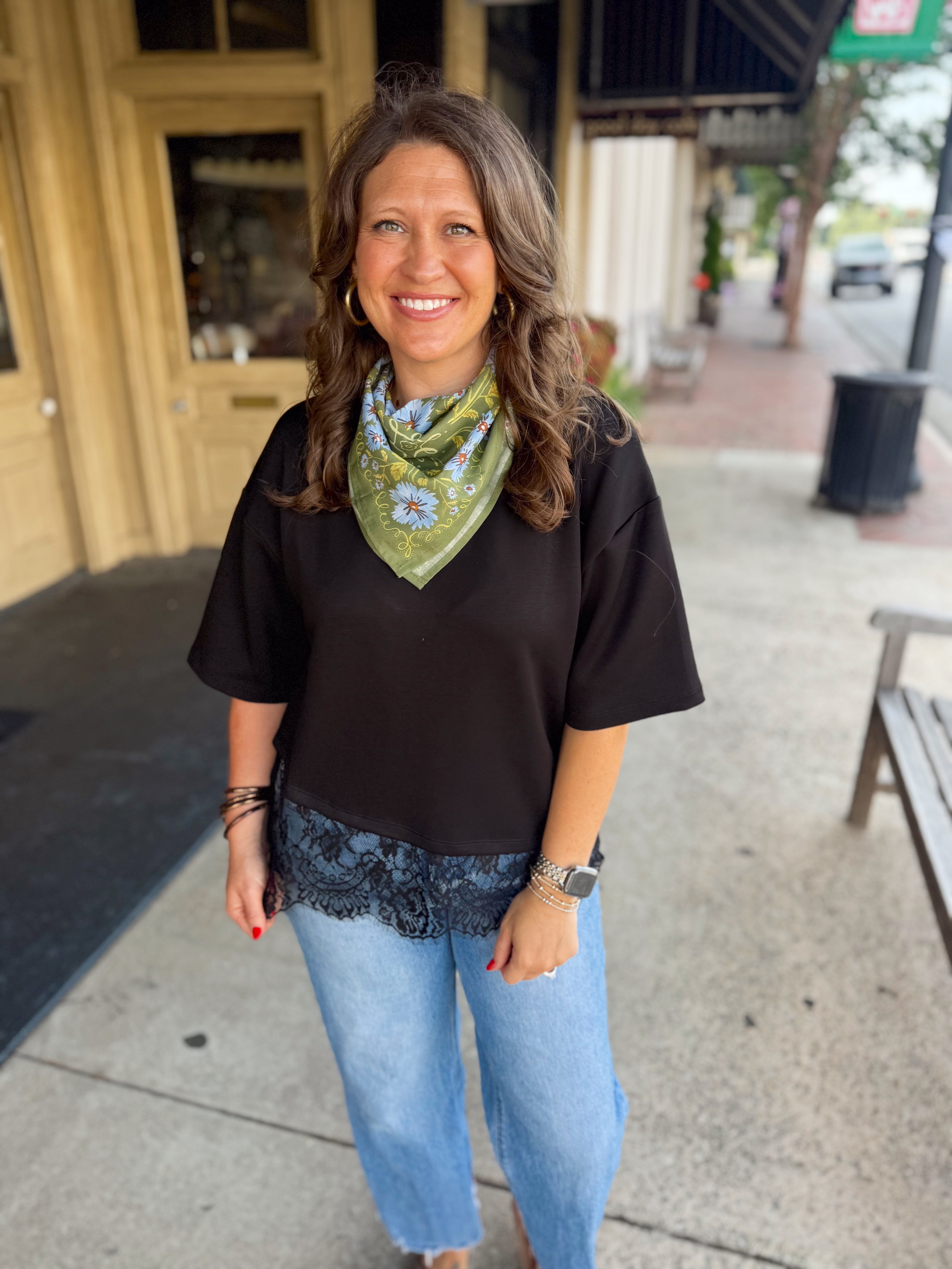 A black short-sleeve top with a lace hem