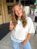 White short-sleeve top with a lace hem
