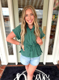 Green and navy striped top with cinching detail around the waist