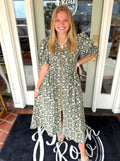 A short-sleeve olive green and white floral print midi dress with a gold front zipper.