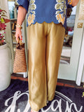  These satin high-waisted pants feature a flattering rise and a flowy wide-leg silhouette that gives them beautiful movement with an elevated finish. 