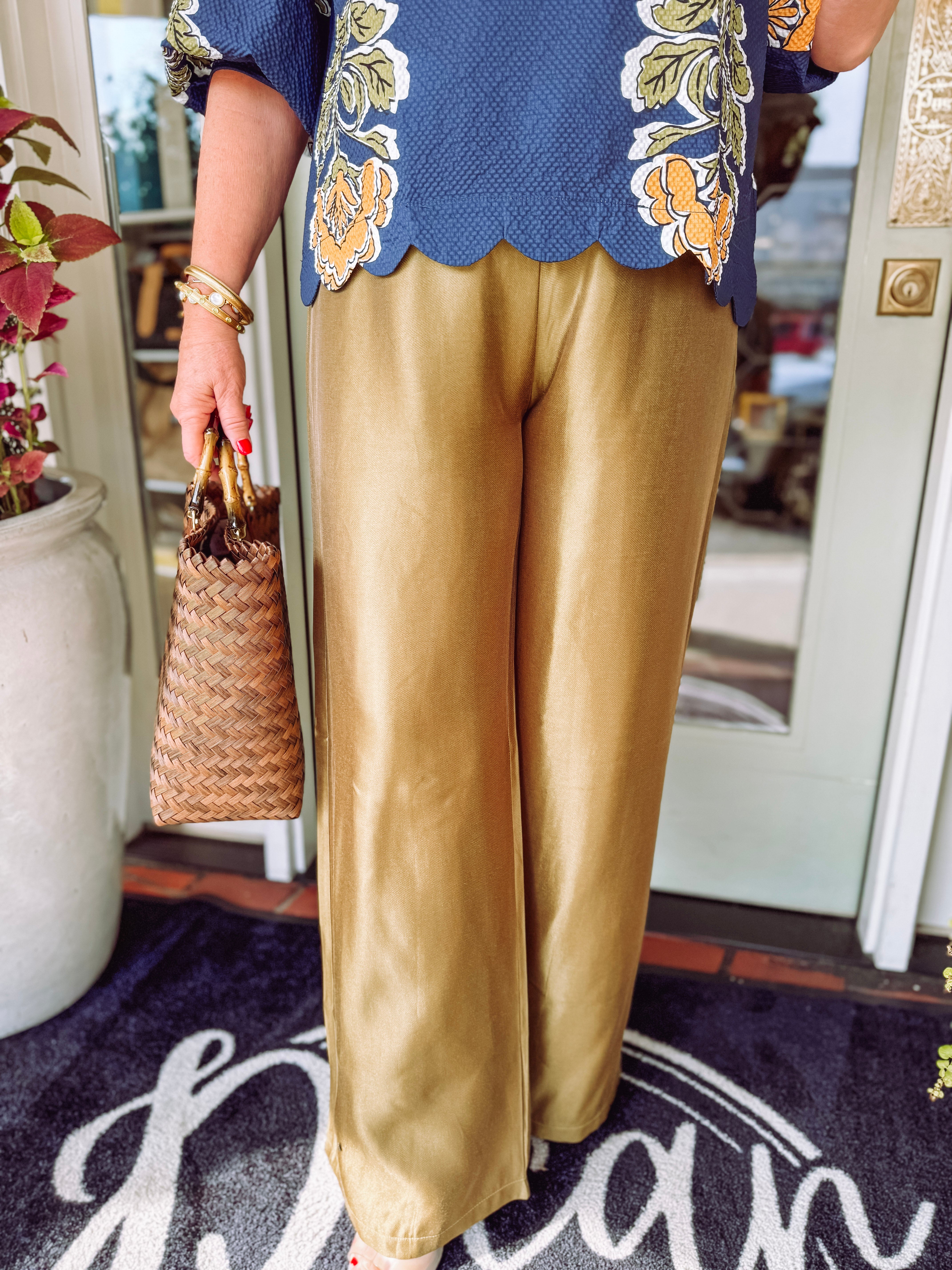  These satin high-waisted pants feature a flattering rise and a flowy wide-leg silhouette that gives them beautiful movement with an elevated finish. 