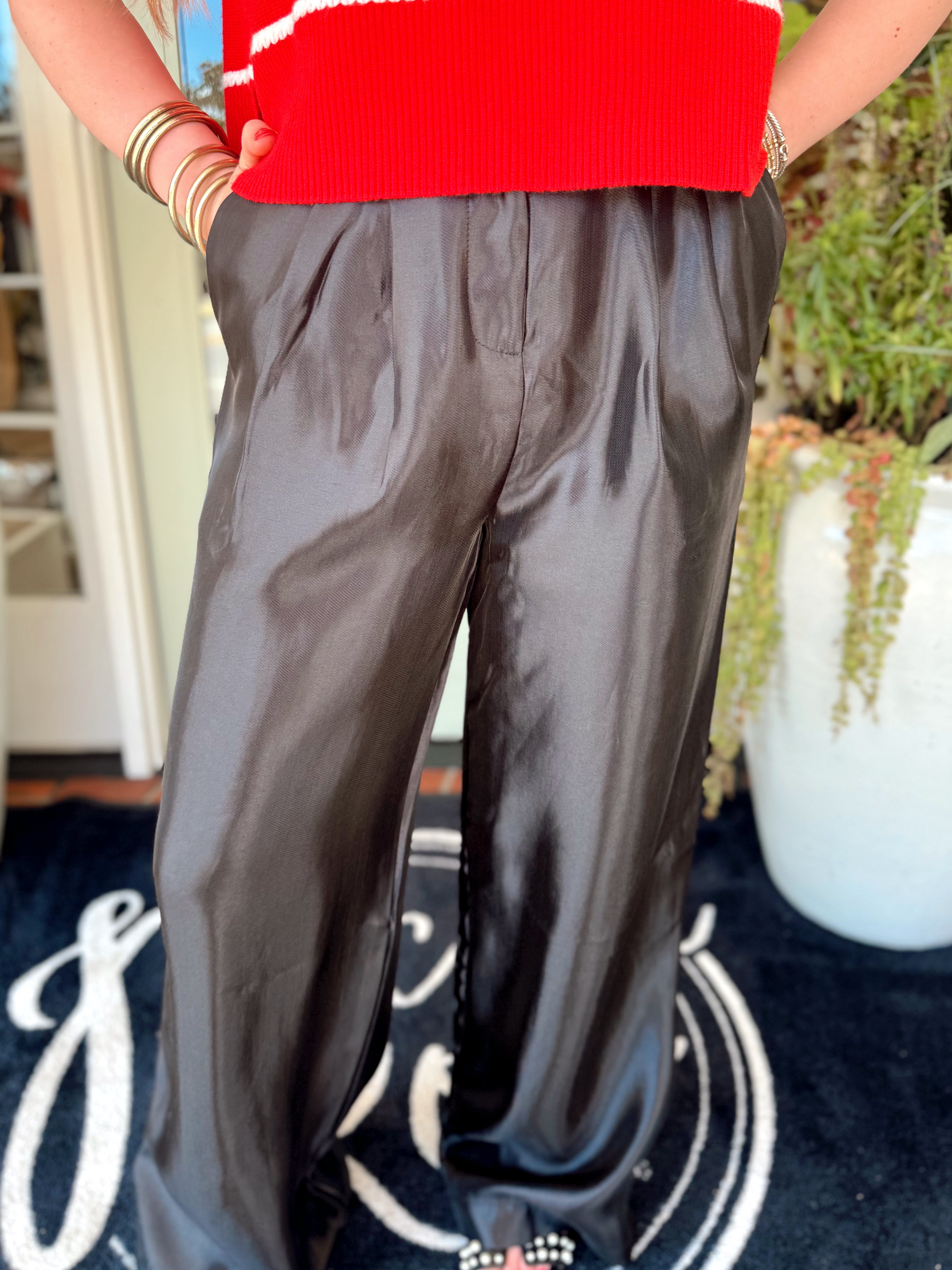 Black satin pleated pants with a high waistband