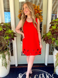  This sleeveless shift dress features a vibrant red color with oversized tonal jewel embellishments around the neckline and hem. 