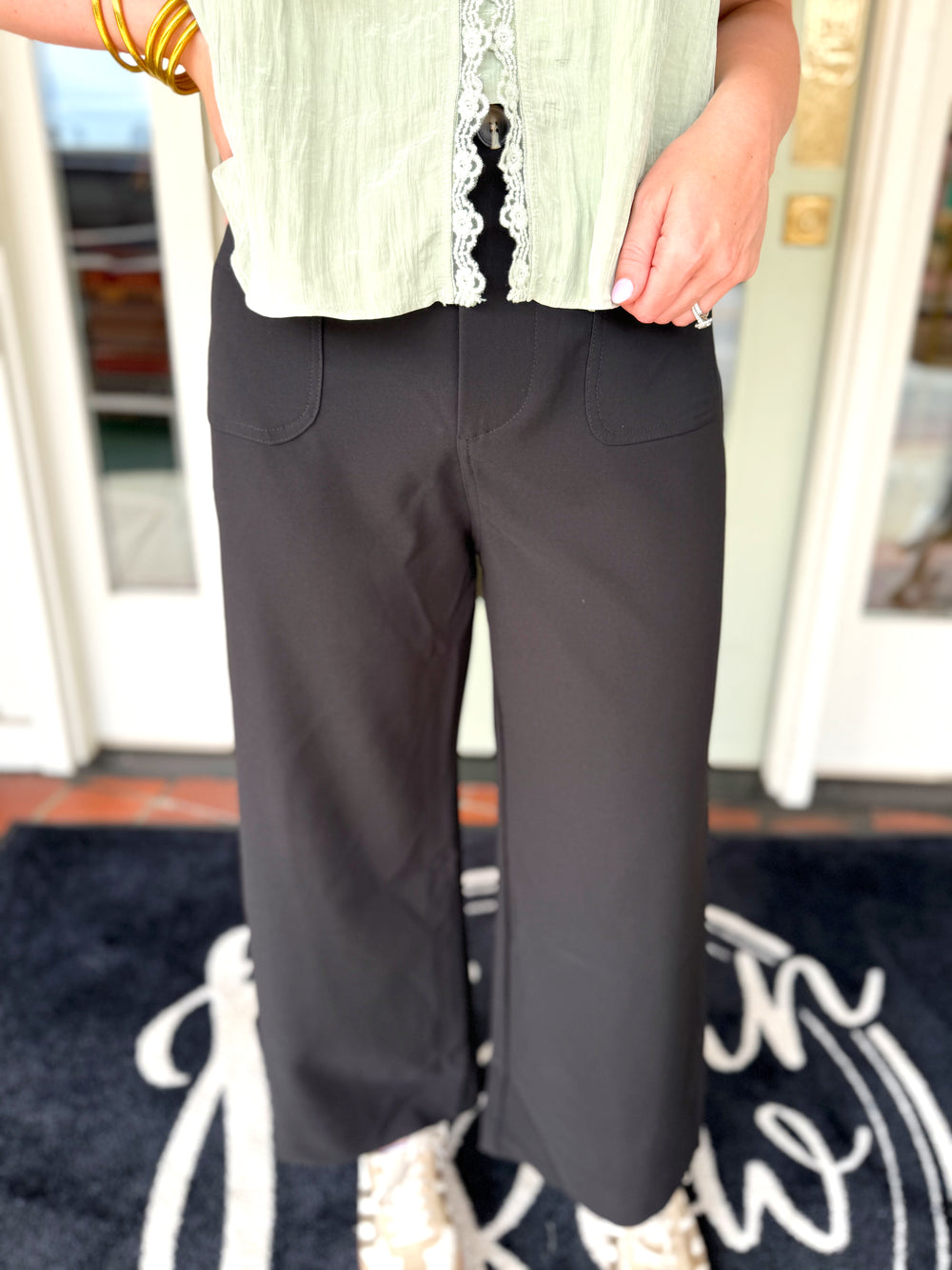 Black wide-leg cropped pants with front patch pockets.