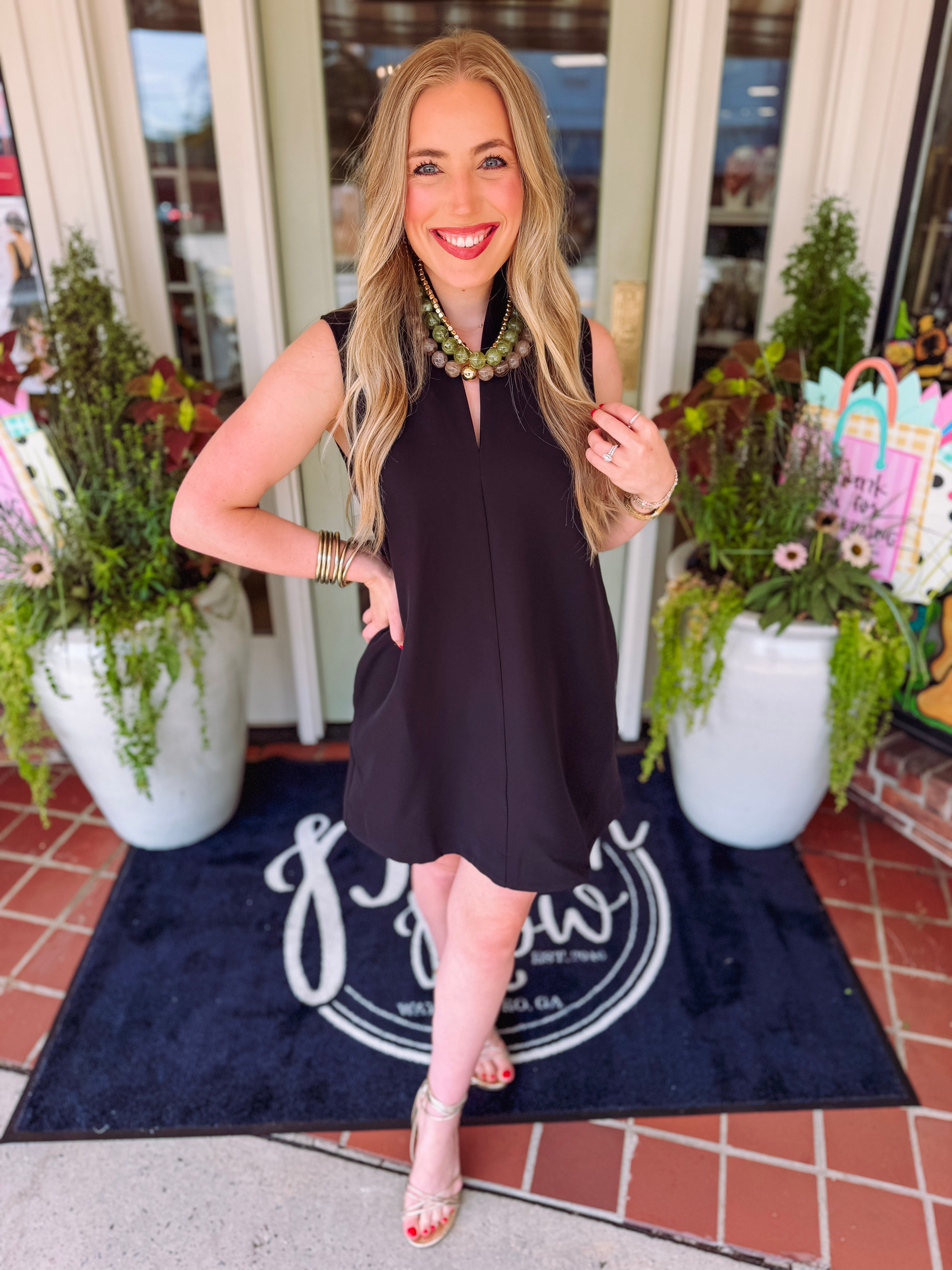 Black stand collar dress with a v-neckline and pockets