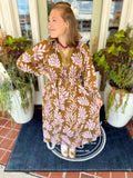 This olive midi dress features an oversized lavender botanical print that gives it a fresh, elevated feel.
