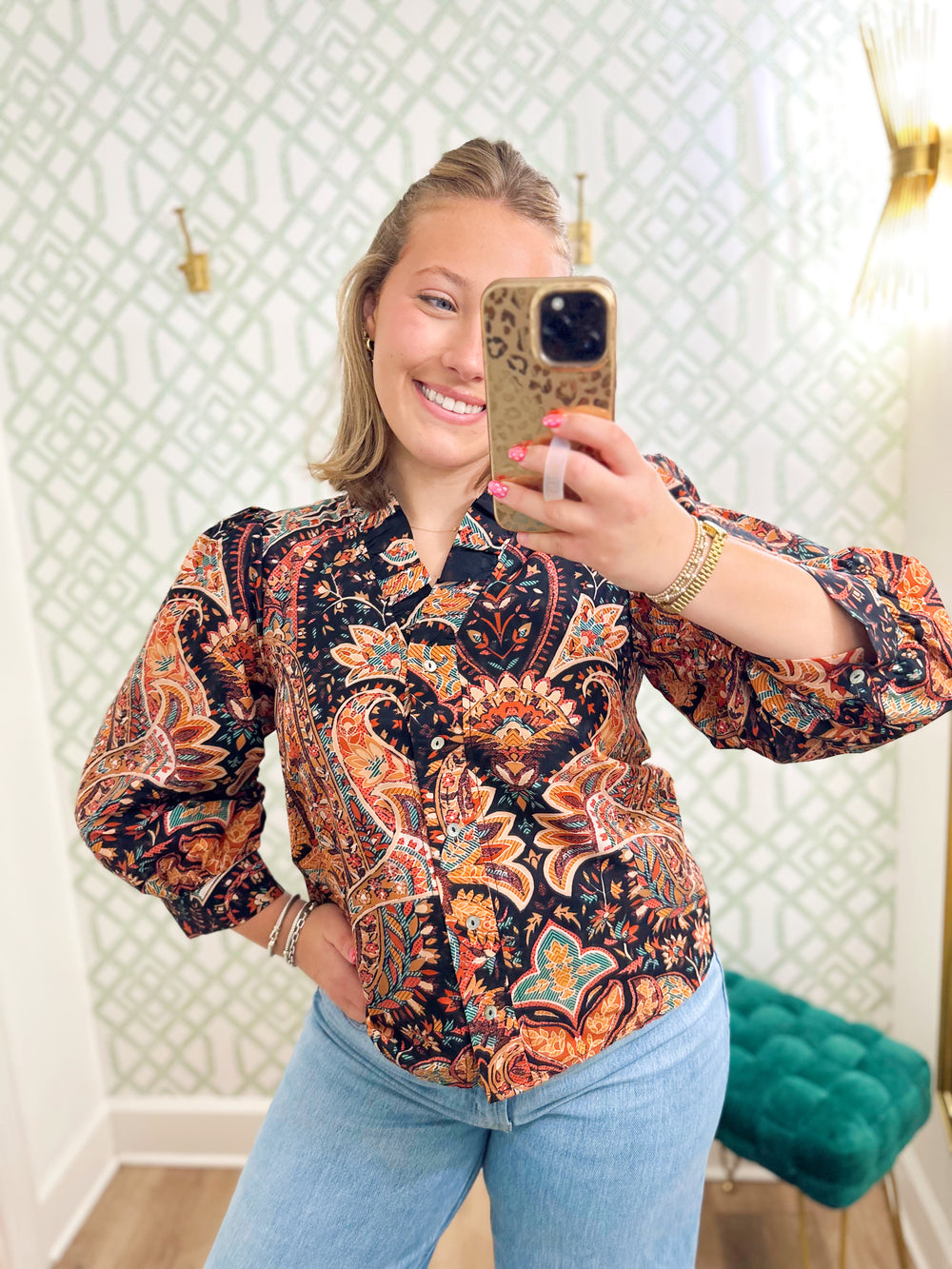 This paisley-inspired blouse features a gorgeous mix of warm rust, coral, teal, and neutral tones against a dark background. 
