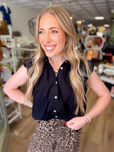 This black top features a collared neckline, button-down front, and a bubble hem that creates an effortlessly styled look without any tucking required.