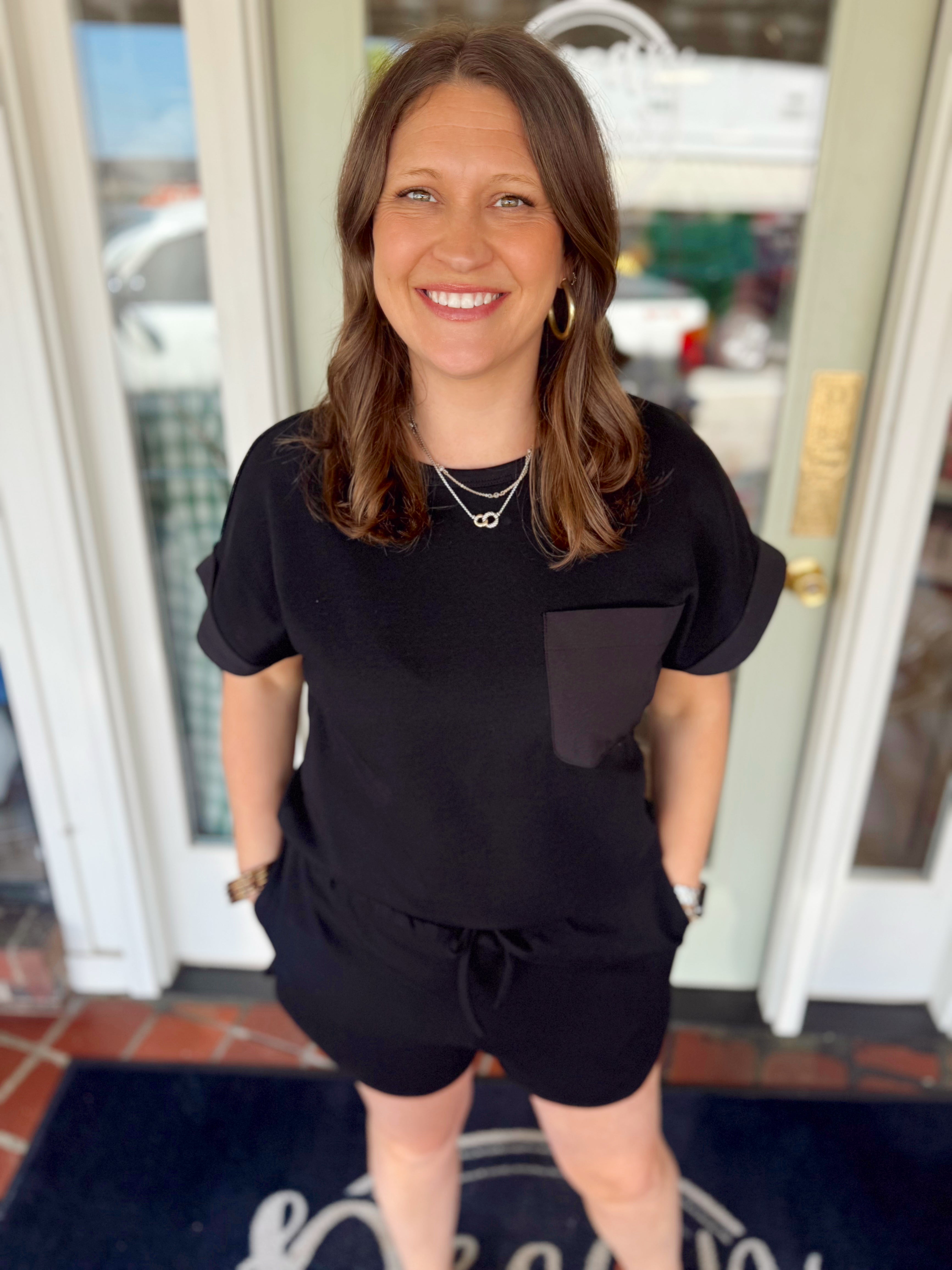 Black short sleeve top with pocket detail on the front 