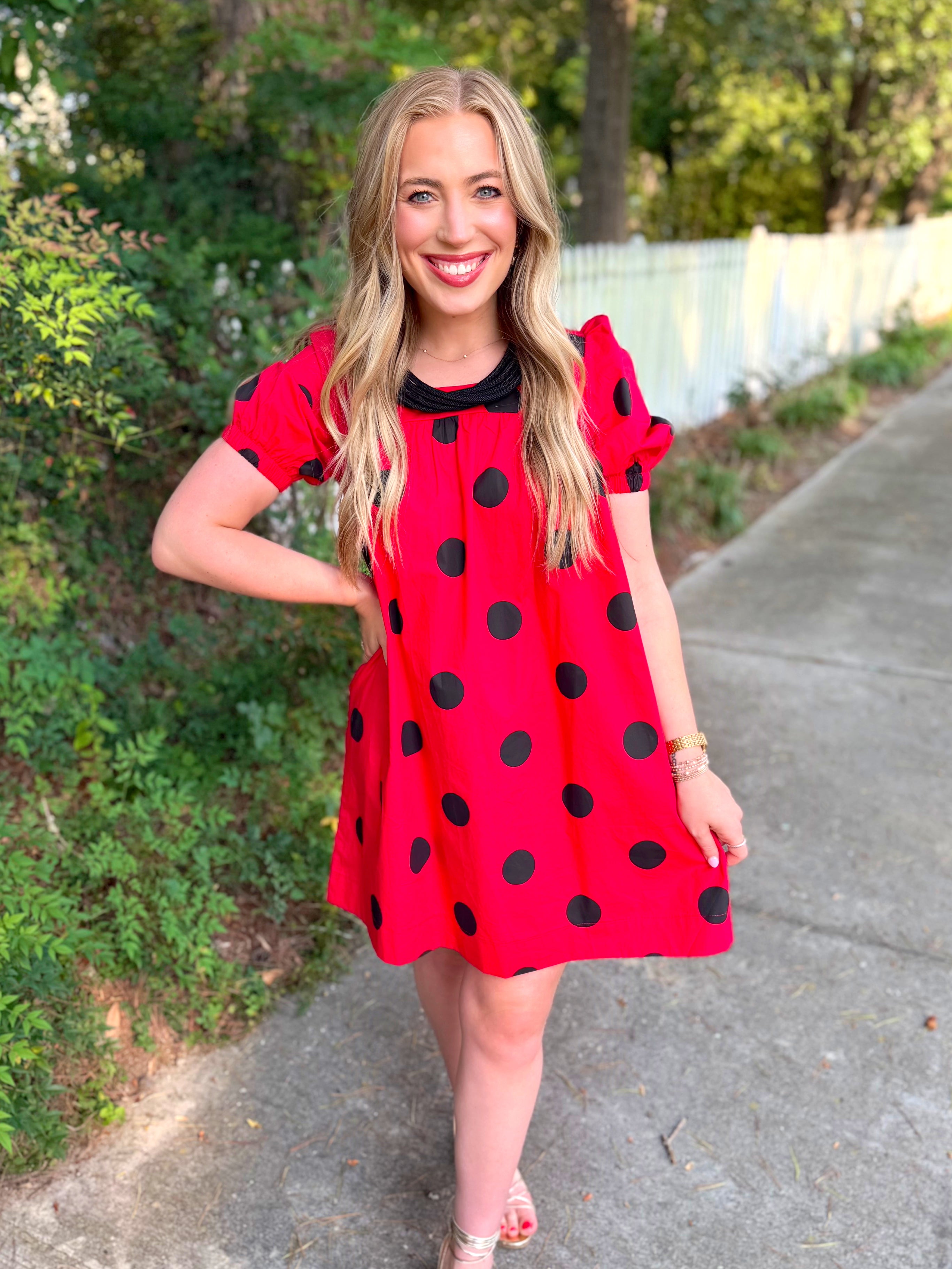 A red short-sleeve dress with large black polka dots.
