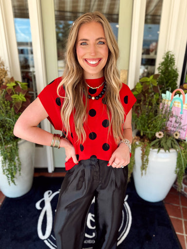 Red with black polka dot sleeveless knit top
