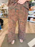  These chocolate brown pants feature the same muted, vintage-inspired floral print in rich olive, rust, and burgundy tones. 