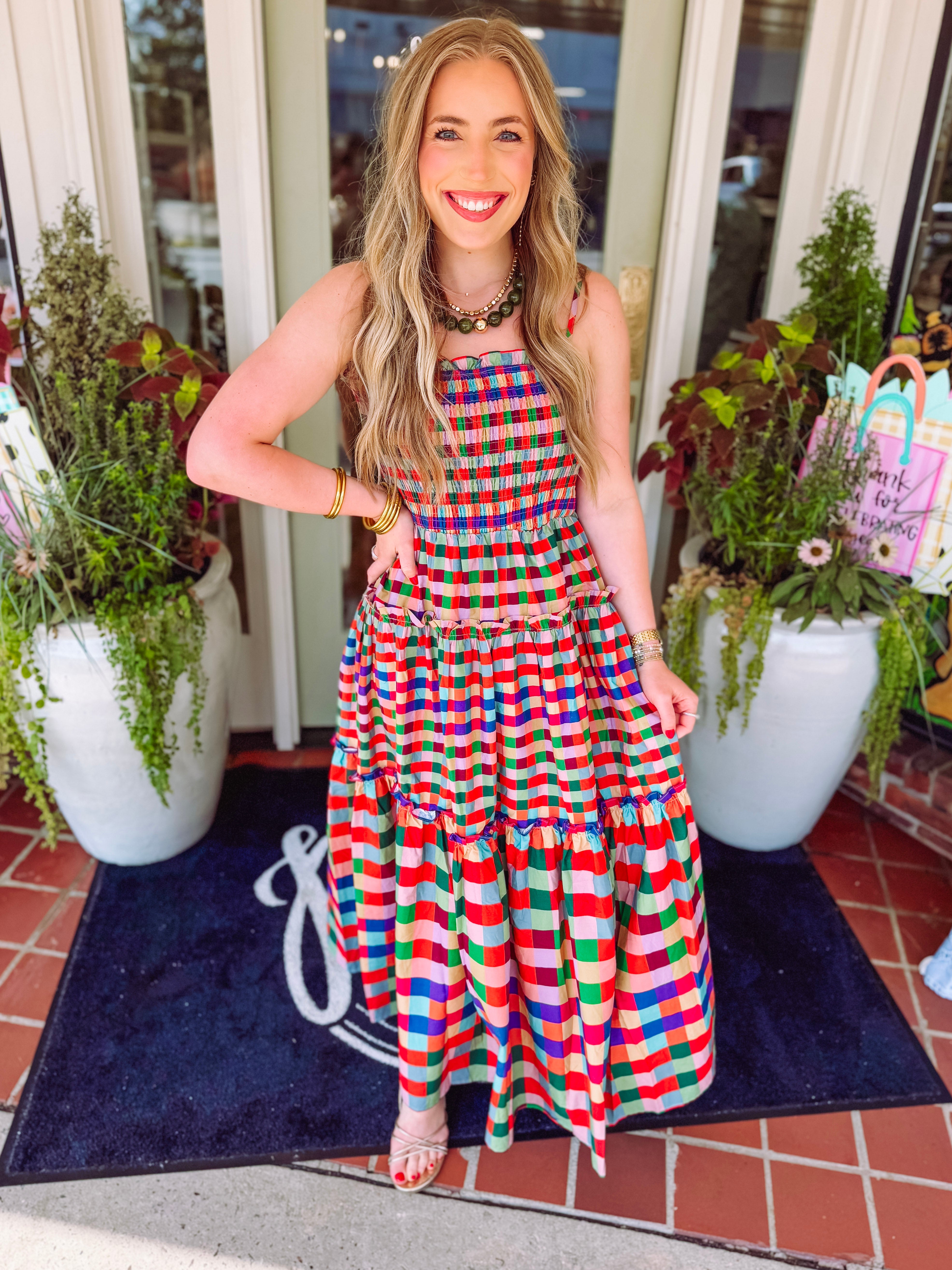 Colorful plaid dress with smocked detailing and a flowwy tiered skirt 
