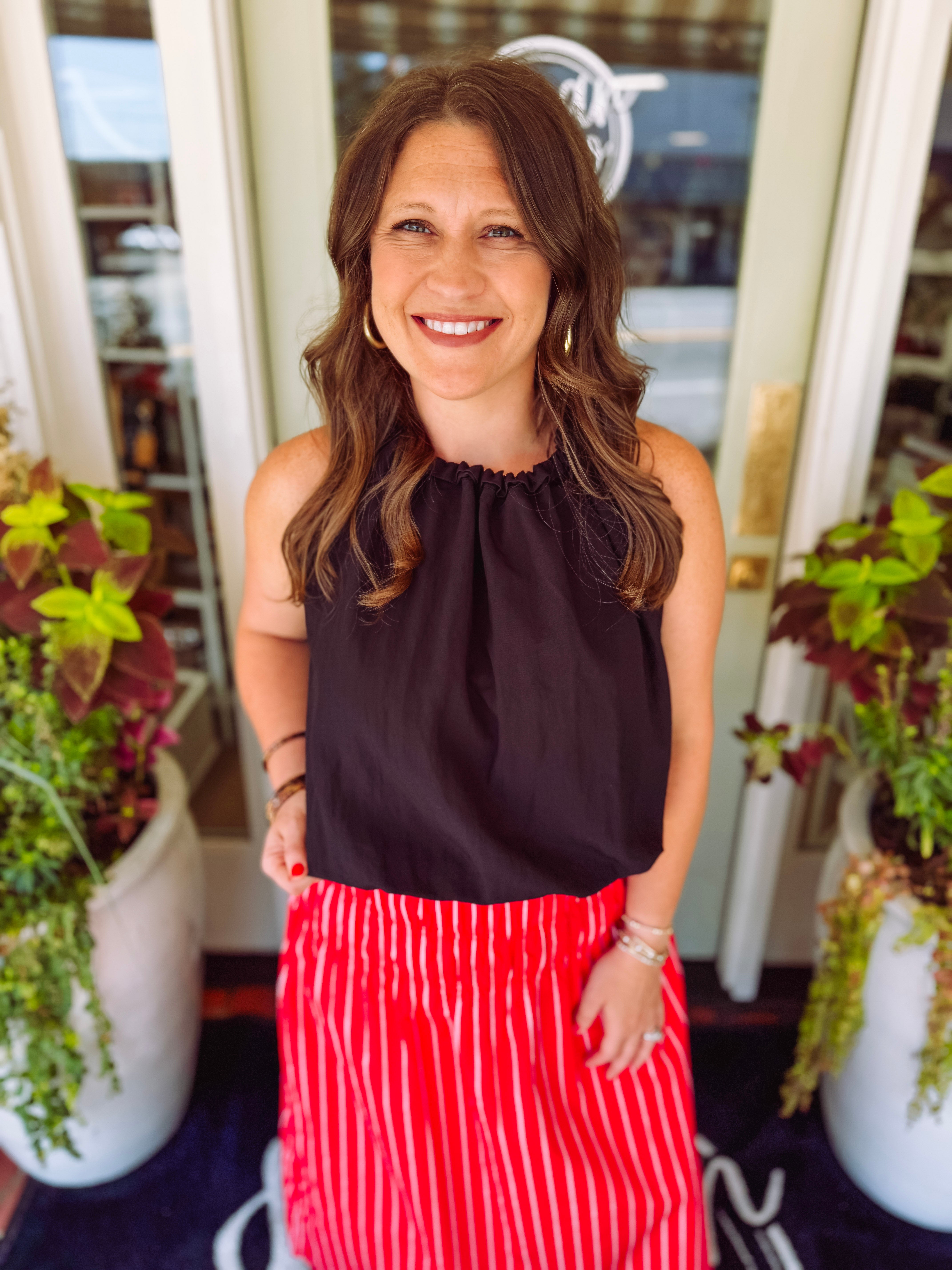 Black bubble hem top with a tie halter neck detail.