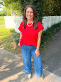A red short-sleeve top with white polka dots.