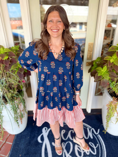 A dress with long sleeves that have elastic wrists for a comfortable fit, a contrast skirt flounce for added movement, and a coordinating back yoke detail.