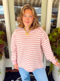 A pink and cream striped waffle knit top with a slit detailing on the sides 