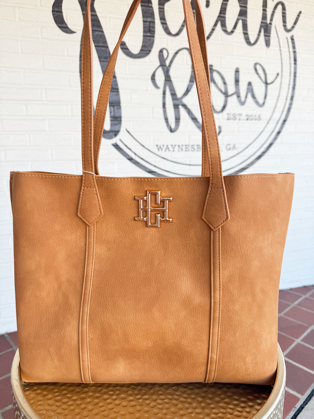 The Heath Tote Bag combines chic style with everyday functionality. Its structured shape add sophistication, while the roomy interior keeps essentials organized with a large center zippered compartment.