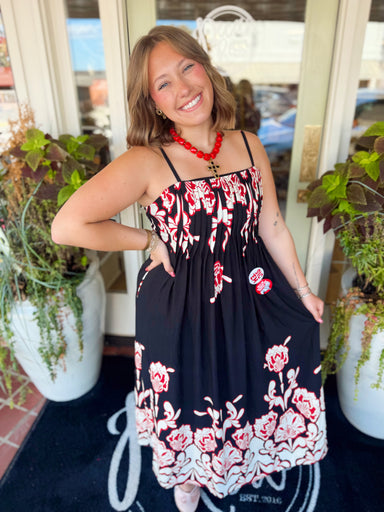 This sleeveless dress features a pretty allover floral print with a clean straight neckline and a flowy maxi-length silhouette.