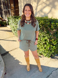 Green and white striped top with brown trim detailing