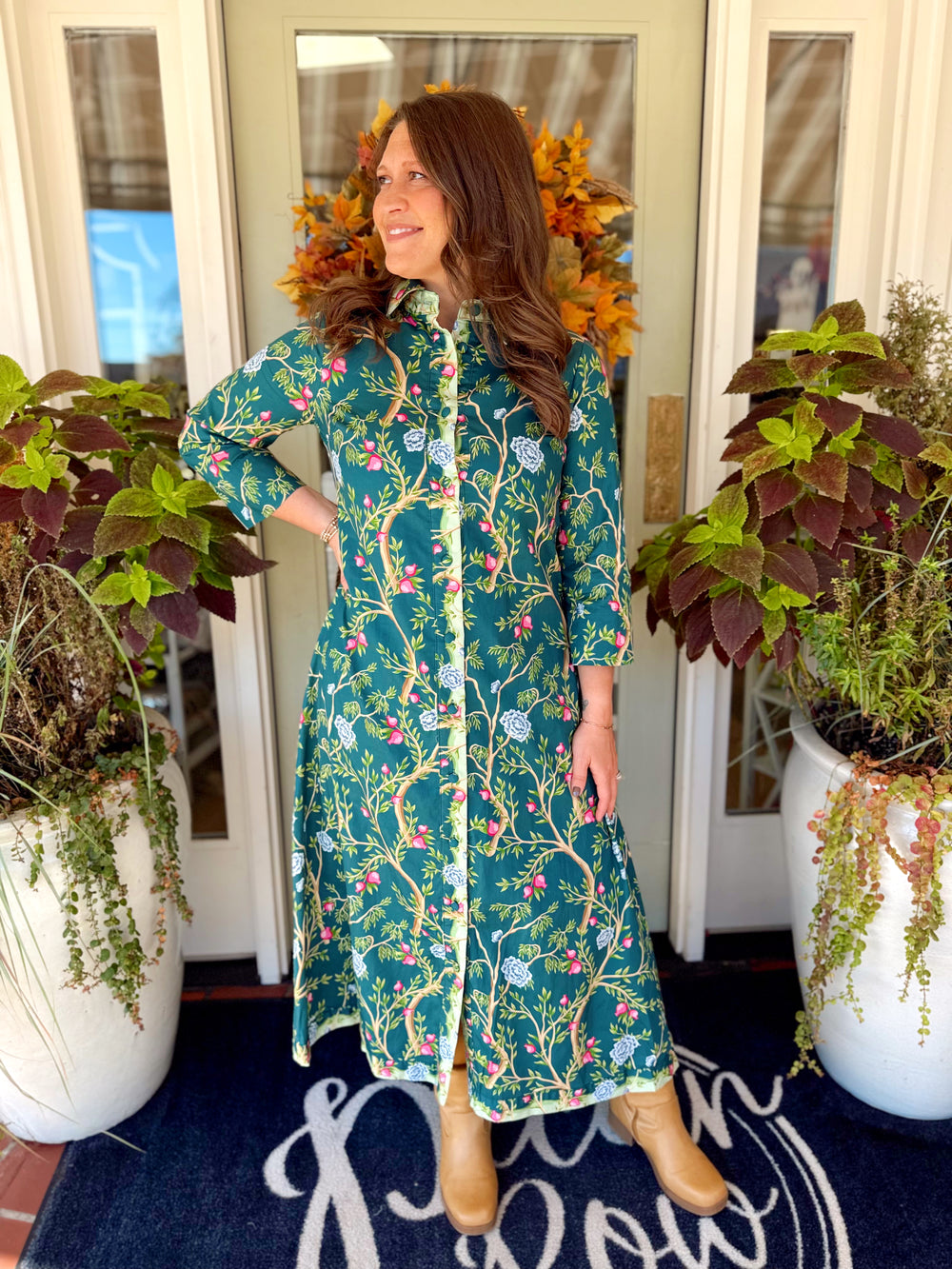 The Jasmine Green Floral Maxi Dress features a beautiful floral print with a classic collared neckline, button-front design, and quarter-length sleeves.