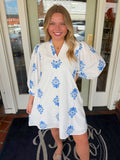 White dress with blue floral embroidered pattern