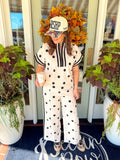  This polka dot top features a relaxed silhouette with a statement striped neckline, half-zip front, and matching striped trim at the sleeves. 