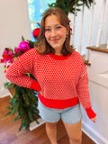 red and white patterned sweater top with slits on the sides
