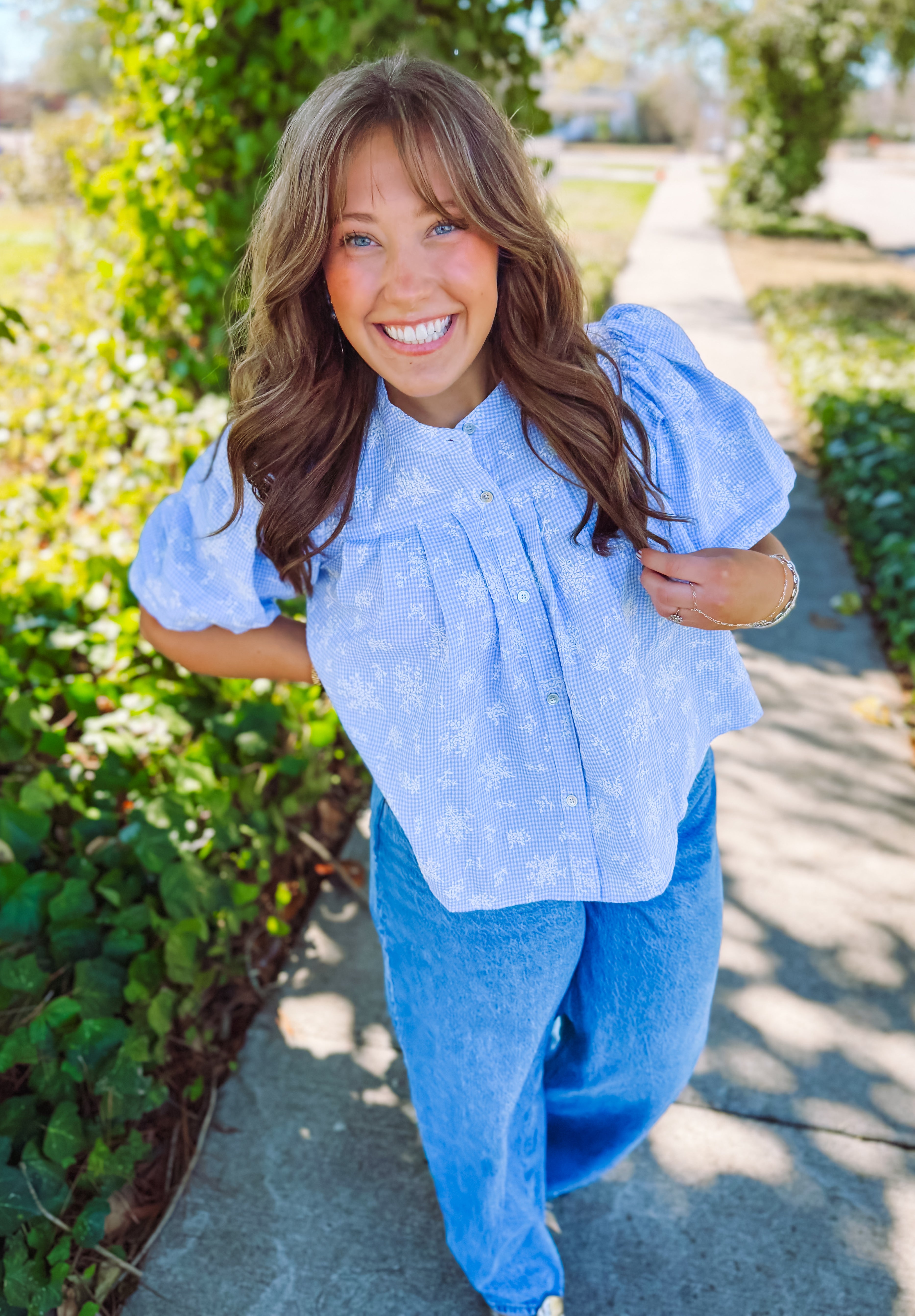 Light blue floral puff sleeve top with white detailing and buttons down the front 