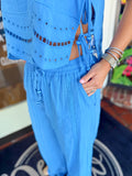 Person wearing a blue outfit with cut-out details 