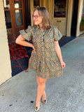 This mini dress features a vintage-inspired medallion floral print in rich olive, rust, and warm neutral tones.
