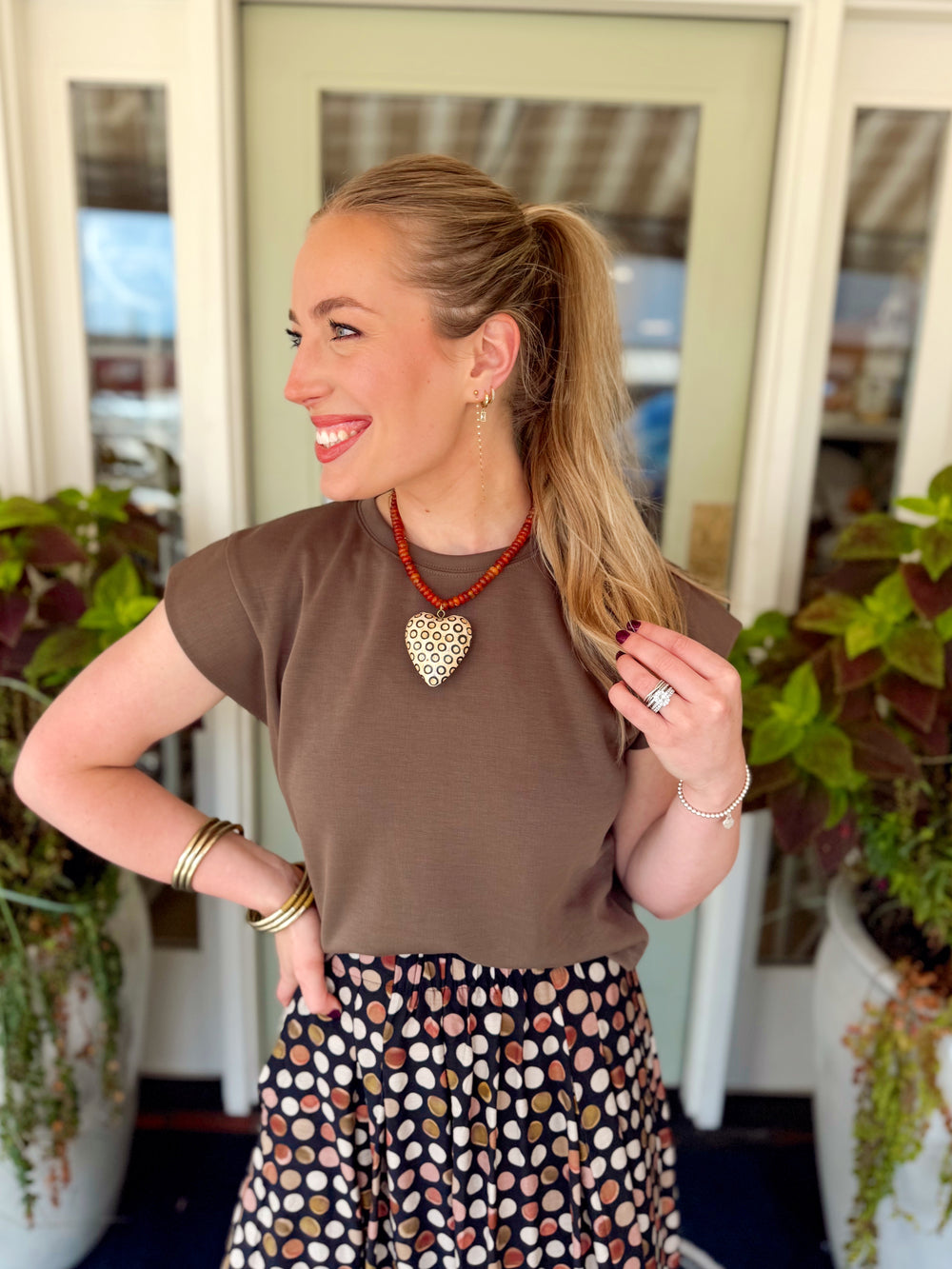  This mocha short sleeve top features a clean crew neckline with a relaxed silhouette and structured cap-style sleeves for a little extra shape. 