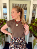  This mocha short sleeve top features a clean crew neckline with a relaxed silhouette and structured cap-style sleeves for a little extra shape. 