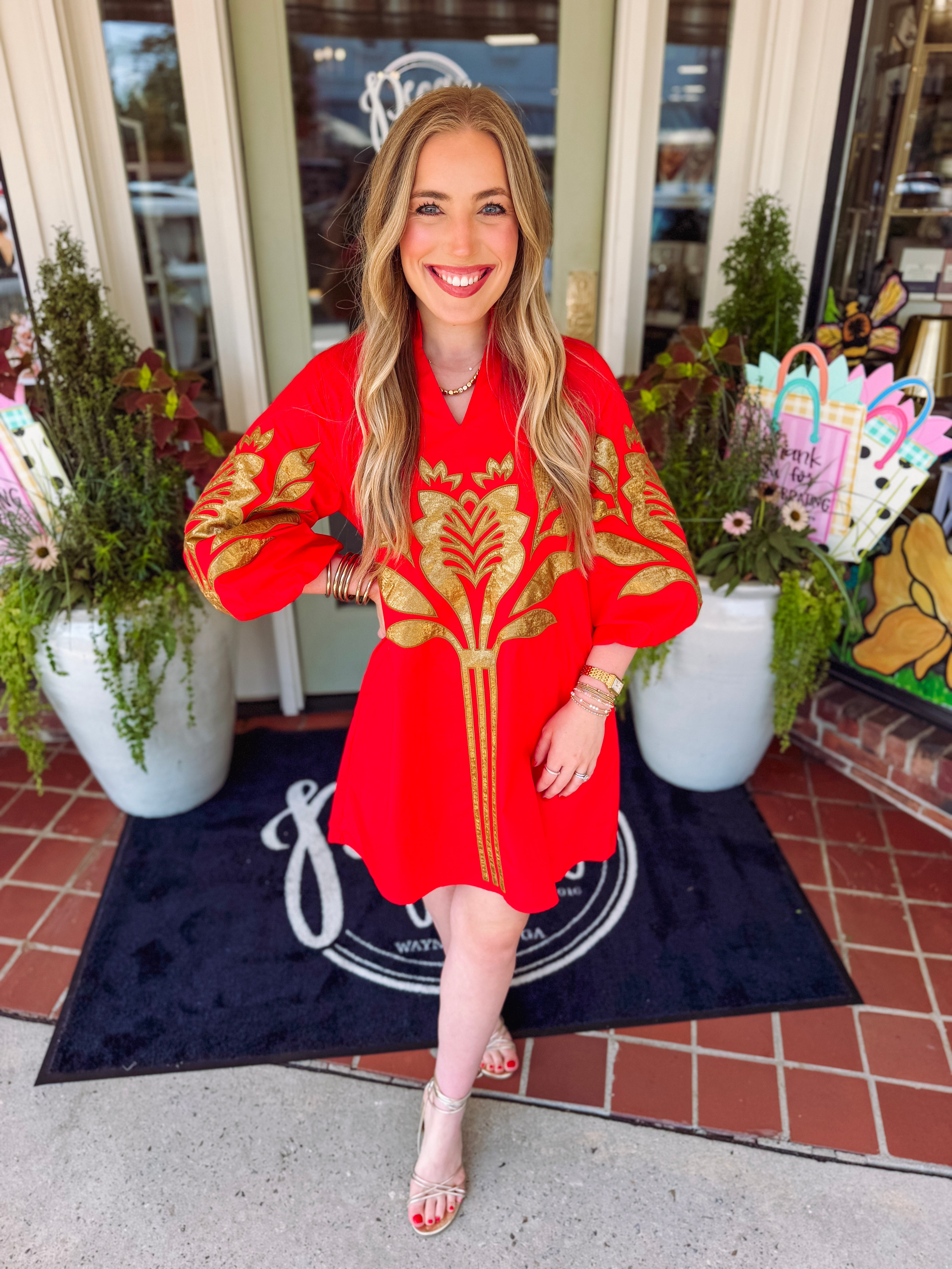 Bright red dress with pockets and gold applique detailing 