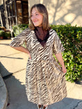 This cream and chocolate zebra print top features a flattering V-neckline, relaxed elbow-length sleeves, and an easy silhouette