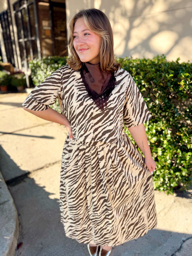 This cream and chocolate zebra print top features a flattering V-neckline, relaxed elbow-length sleeves, and an easy silhouette