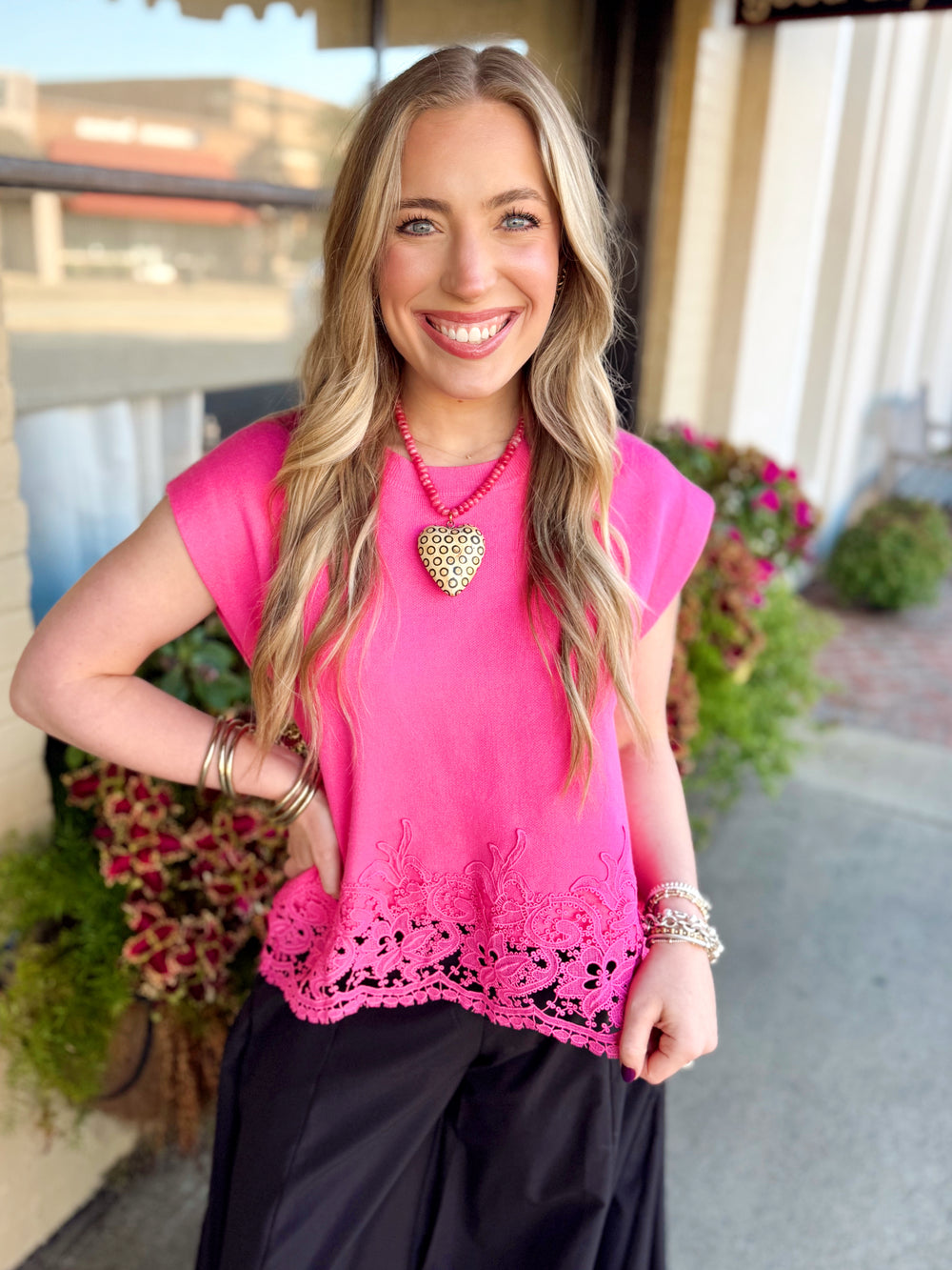 This soft knit top features delicate embroidered lace detailing along the hem, adding just enough texture and charm to make it feel special.