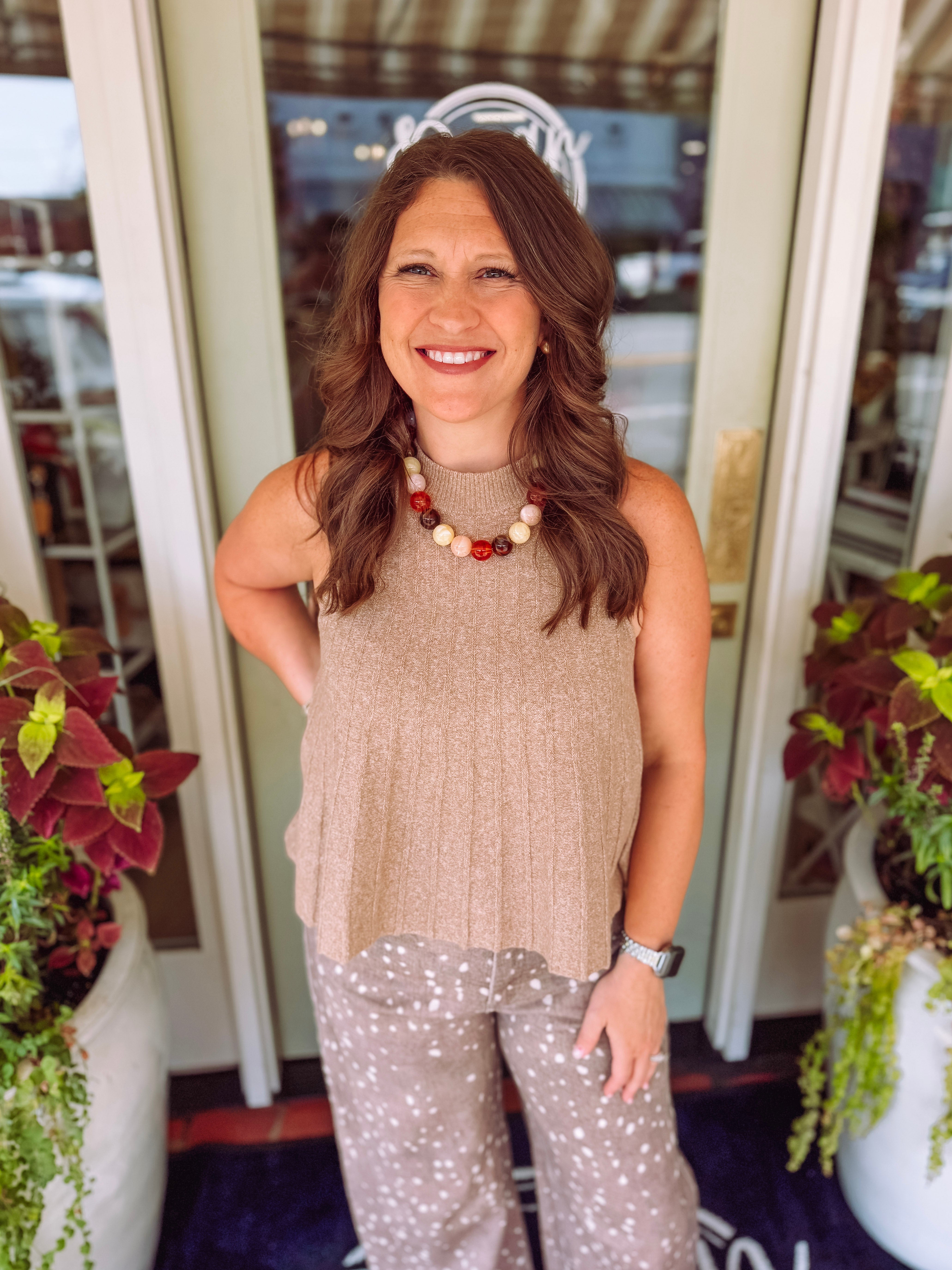 Taupe ribbed sweater knit vest with a mock neckline